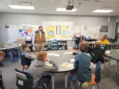 Image of a volunteer with group of students